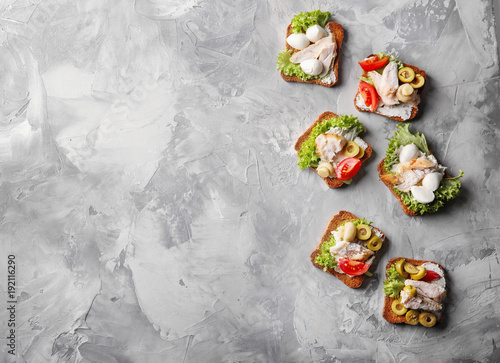 Tasty chicken bruschettas on table