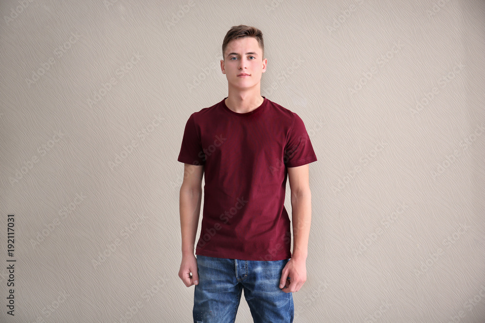 Young man in color t-shirt on light background. Mockup for design Young man in color t-shirt on light background. Mockup for design