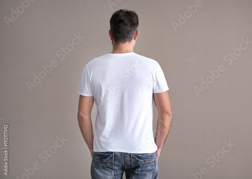 Man in color t-shirt on light background. Mockup for design