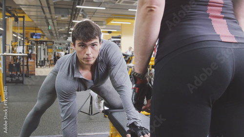 In the gym - athlete man lifting dumbbells