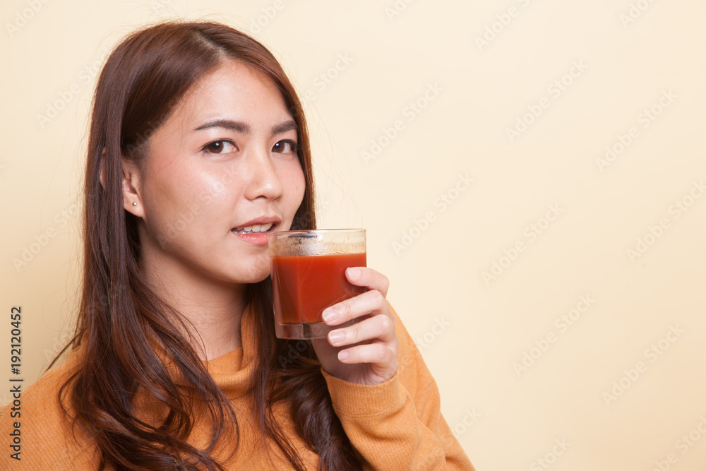 Young Asian woman drink tomato juice. Young Asian woman drink tomato juice.