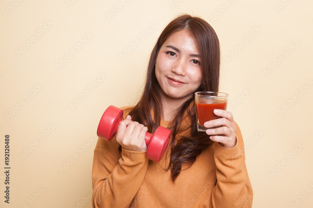 Healthy Asian woman with dumbbell and tomato juice. Healthy Asian woman with dumbbell and tomato juice.