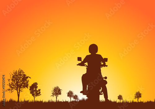 Silhouette of motorcyclists on nature at sunset.