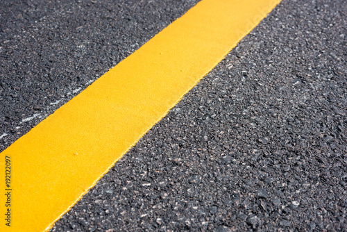 Asphalt road, yellow line on the new road