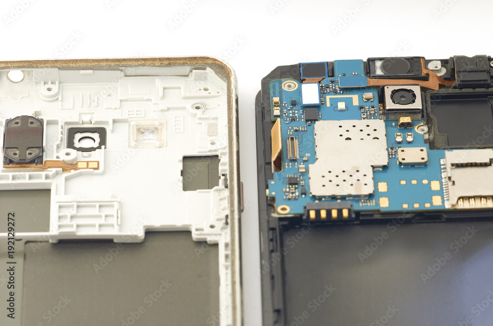 Disassembly of smartphone showing electrical board inside. The phone is fixing Disassembly of smartphone showing electrical board inside. The phone is fixing