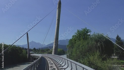 Bergbahn auf die Hungerburg bei Innsbruck überquert den Inn und fährt in Tunnel photo