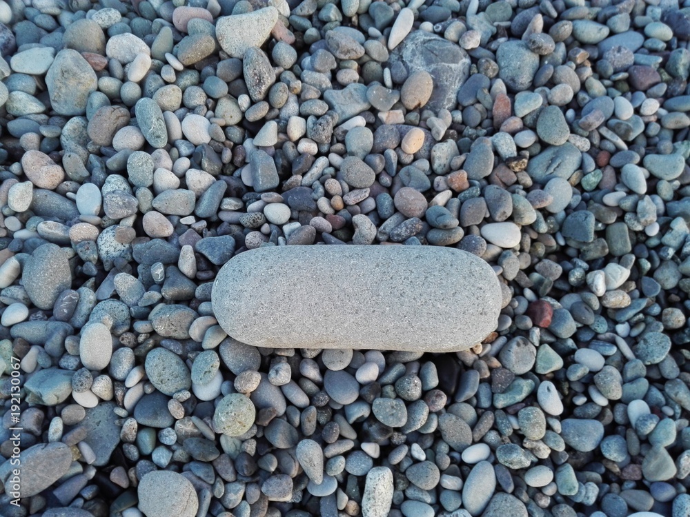 Big gray sea pebble stone or rock in minus shape as frame on beach. Pebble stone hyphen dash natural abstract texture or background frame. Pebble stone frame on seacoast. Pebble stone in gravel frame Big gray sea pebble stone or rock in minus shape as frame on beach. Pebble stone hyphen dash natural abstract texture or background frame. Pebble stone frame on seacoast. Pebble stone in gravel frame