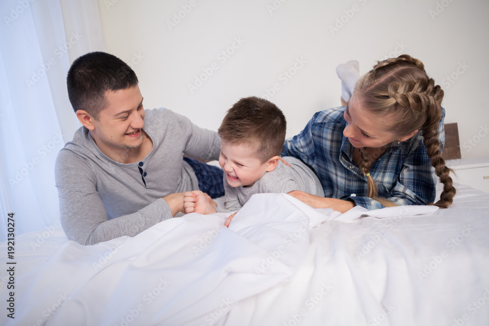 mom and dad and little boy in the bedroom mom and dad and little boy in the bedroom