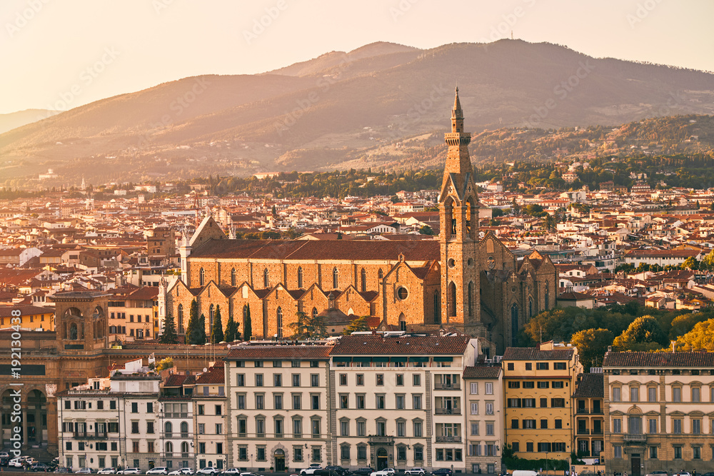 Panorama of Florence at sunset with the Basilica di Santa Croce (Basilica of the Holy Cross) illuminated by the setting sun. Basilica of the Holy Cross in sunset time.