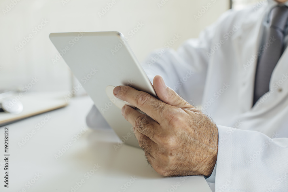 Doctor Holding Tablet