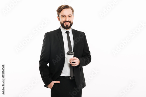 Cheerful young businessman standing isolated