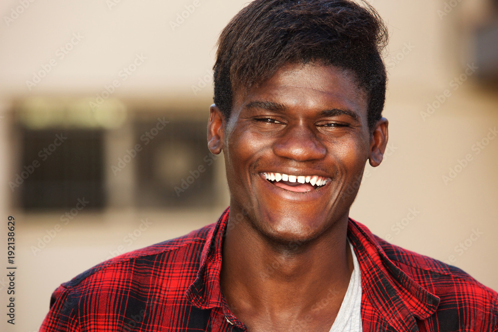 Close up handsome young man laughing