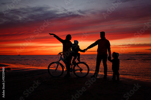 Family on the sunset on the beach