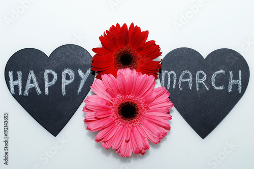 Postcard on March 8 - International Women's Day.
Beautiful gerberas and chalk inscription on the decorative heart "Happy March 8"