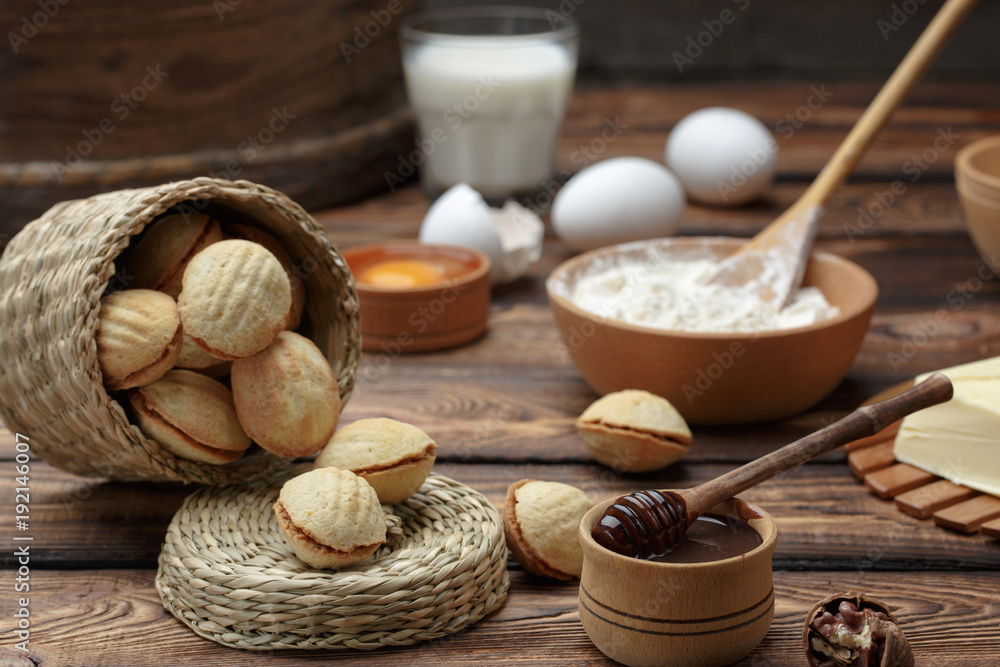 homemade cookies shaped nuts with cream boiled condensed milk on wooden table.