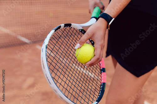 Tennis player. Close-up view of women's hand preparing to hit a ball, playing tennis on the court. © Maksym Azovtsev