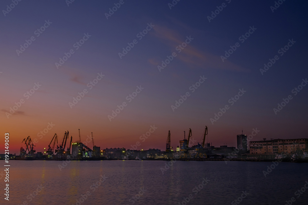 Naklejka premium Sunset over the seaport 2