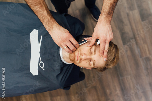 Barber shave and modeling beard at the hair salon