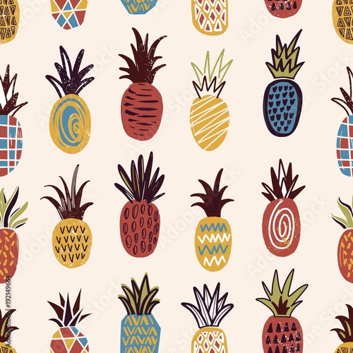 Seamless pattern with pineapples of various color and texture on light backgr...
