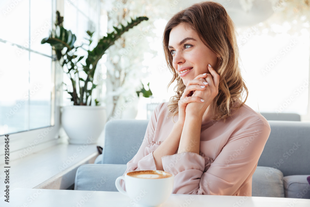 Portrait of a lovely young woman having cup of coffee Portrait of a lovely young woman having cup of coffee