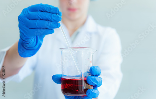 Research scientist stir and mixing liquid chemical in beaker