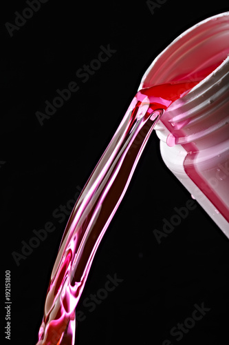 Pouring antifreeze in the engine cooling system of the car.