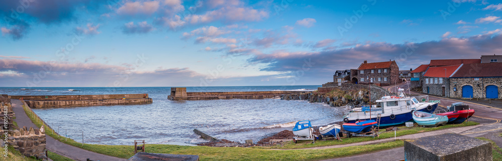 Panorama of Craster Harbour / Craster is a small fishing village on the Northumberland coast, with a small harbour and views to the ruins of Dunstanburgh Castle