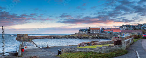 Fotografie Craster Harbour and Village Panorama / Craster is a small fishing village on the