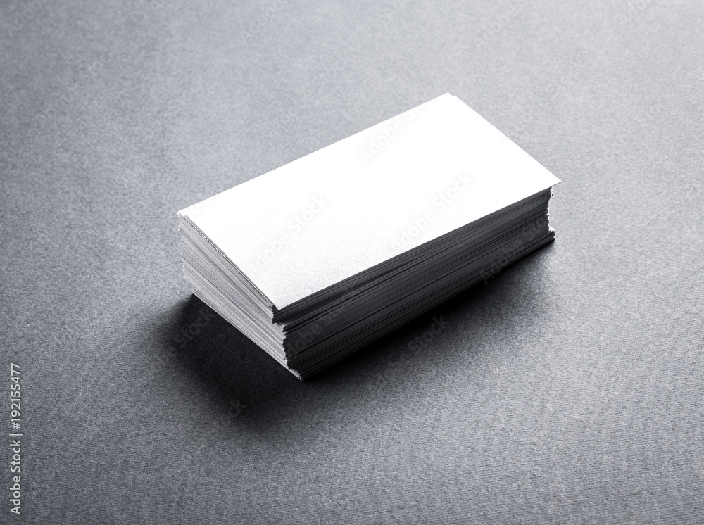 Stack of blank white business card on grey background. Blank name card. Stack of blank white business card on grey background. Blank name card.