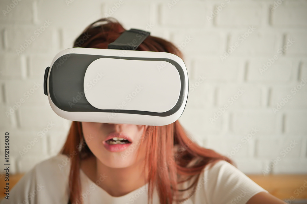 stunned fearful woman playing horror or suspense VR headset stunned fearful woman playing horror or suspense VR headset