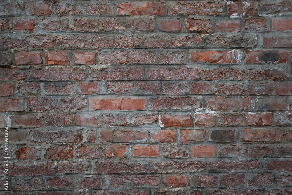 Obraz premium Old brick wall as background, texture or pattern. Dark red and orange brick wall. Poster or cover.