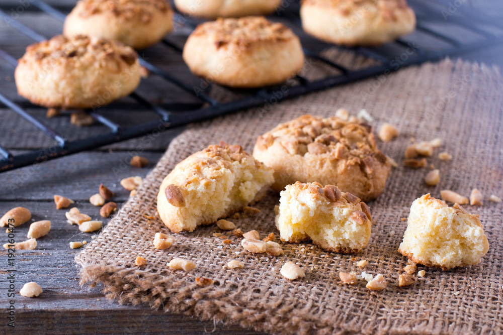 Taking freshly baked cookies out of an oven. Biscuits with peanuts and honey Taking freshly baked cookies out of an oven. Biscuits with peanuts and honey