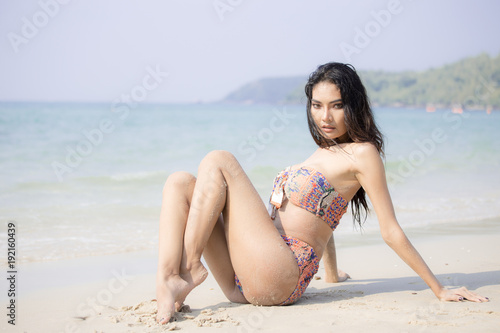 Beautiful asian woman posing at the the ocean.