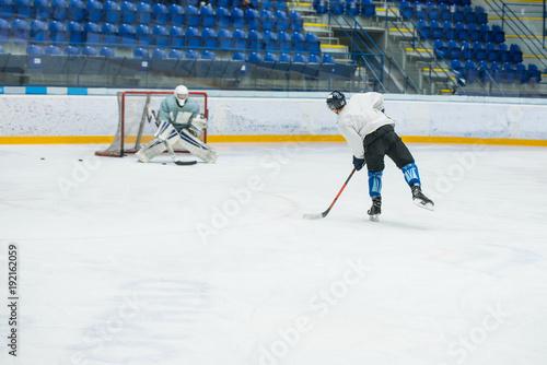 Hockey game, professional hockey players and hockey goalie on ice
