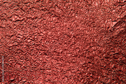 Texture of crumpled red foil. Metallic background