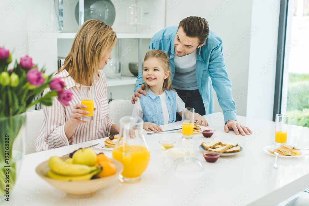 happy family having breakfast together at home happy family having breakfast together at home