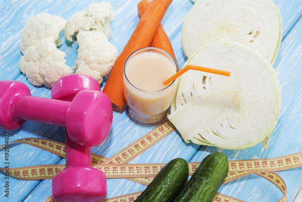Fitness concept with dumbbells and healthy food. Fitness concept with dumbbells and healthy food.