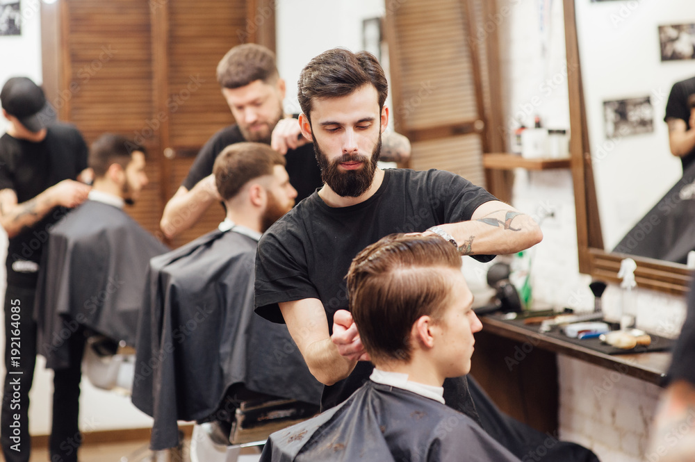 man getting trendy haircut at barber shop. man getting trendy haircut at barber shop.
