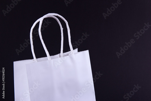 white paper bag on black background
