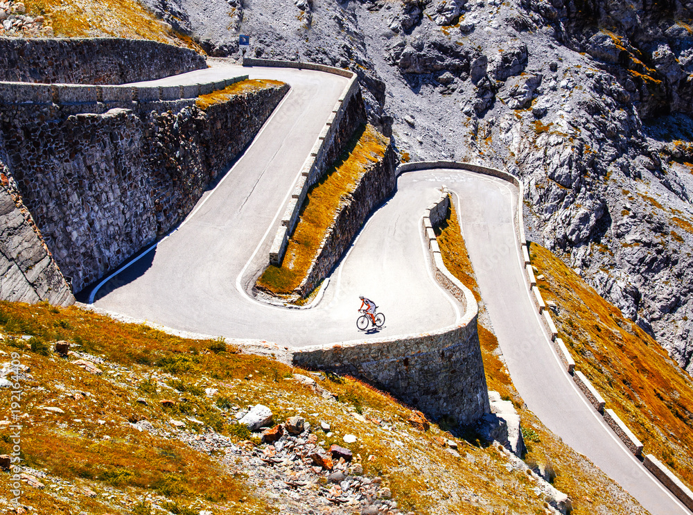 Fototapeta premium Biker on the road - Cyclist photo. Tour, Italy, Passo dello Stelvio