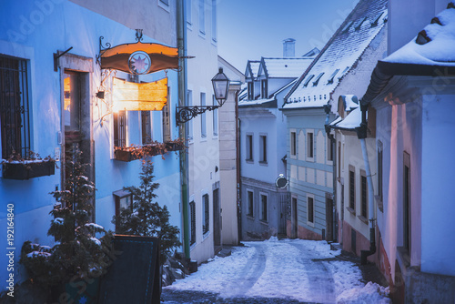 Beautiful winter city street, old houses, city lamp, in winter evening. Romantic Christmas evening. © kovop58