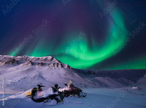 The polar arctic Northern lights aurora borealis sky star in Norway Svalbard in Longyearbyen city snowscoter mountains