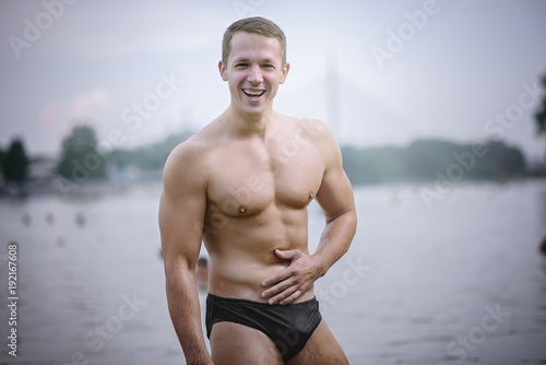 Young athletic caucasian man posing on the beach