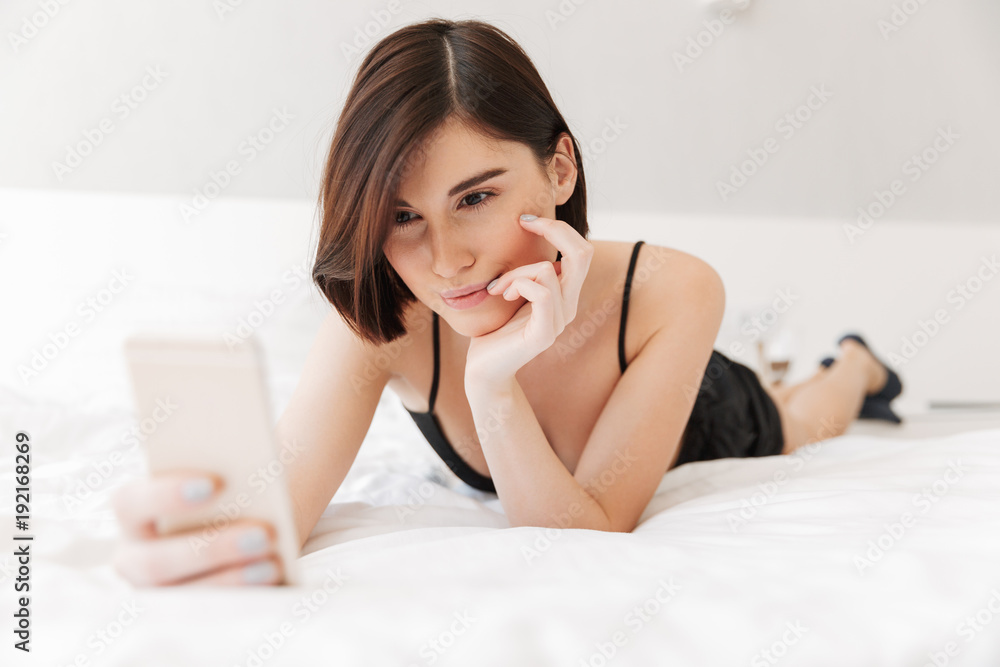 Portrait of a smiling young woman using mobile phone Portrait of a smiling young woman using mobile phone
