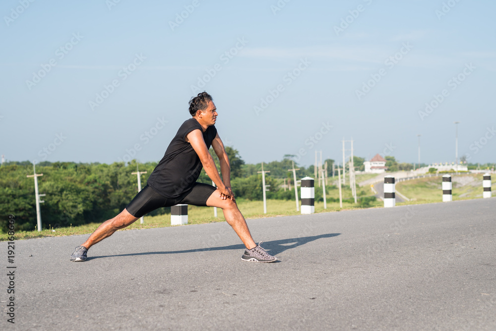 Male runners are stretching the leg muscles to prepare for a run in the morning. The concept of health and fitness Male runners are stretching the leg muscles to prepare for a run in the morning. The concept of health and fitness