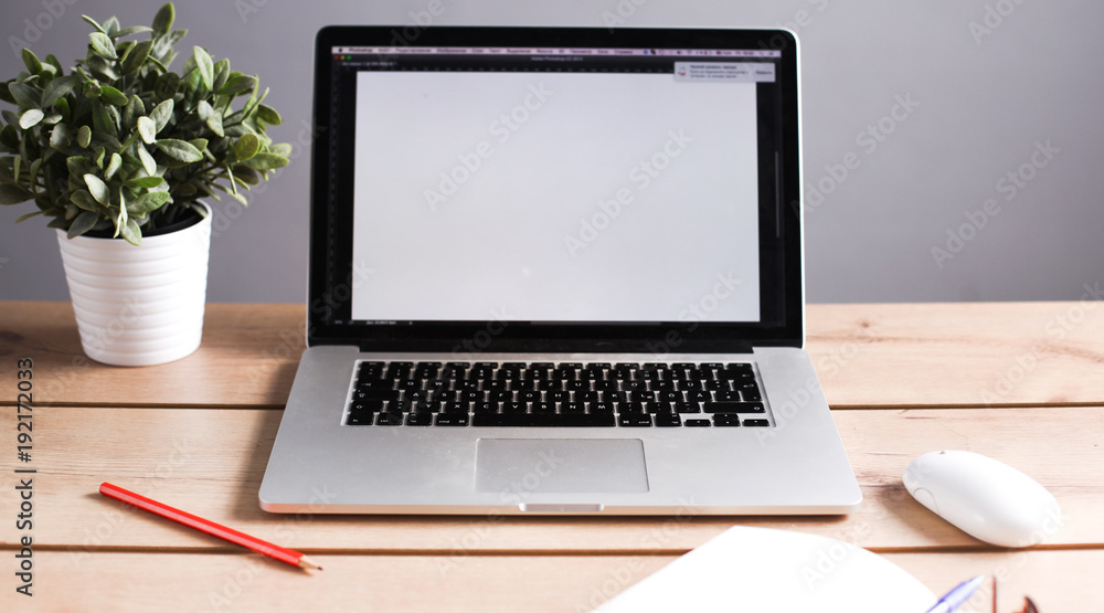Fototapeta premium Laptop stands on a wooden table