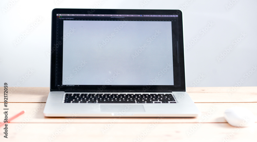 Fototapeta premium Laptop stands on a wooden table