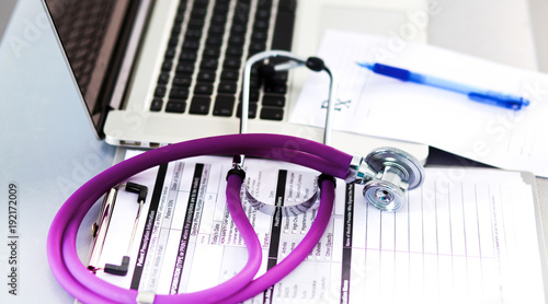 Stethoscope resting on a computer keyboard - concept for online medicine or IT support