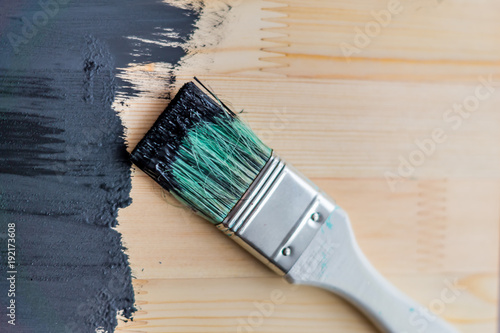 black paint on wooden background. selective focus