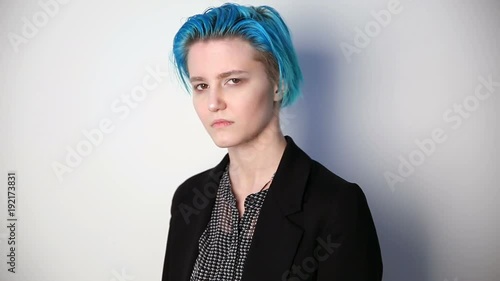 modern youth. calm portrait of a serious girl of unusual appearance with blue hair. photo